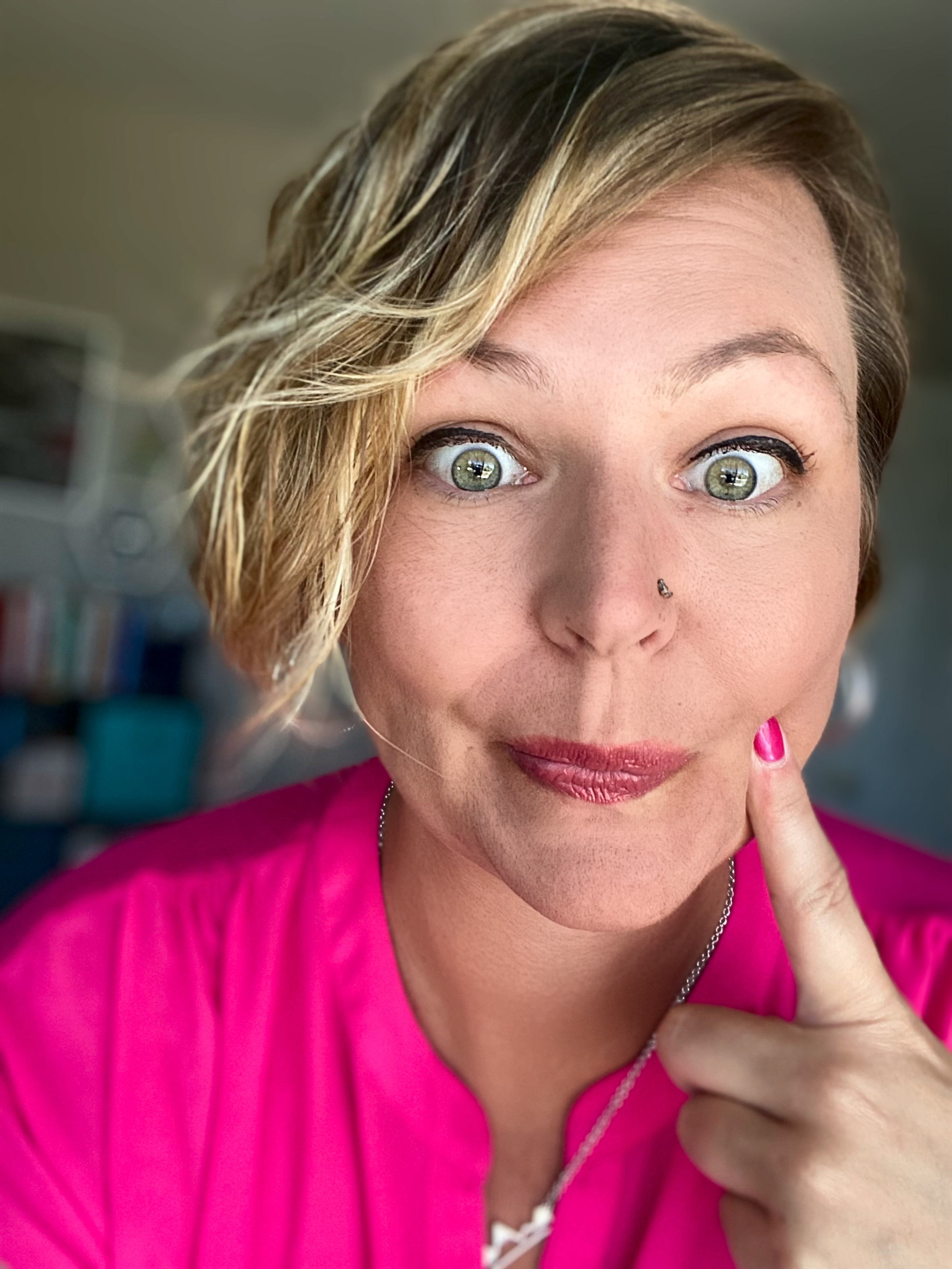 Samantha smiling playfully, holding her finger to her lips, representing her approachable and fun personality